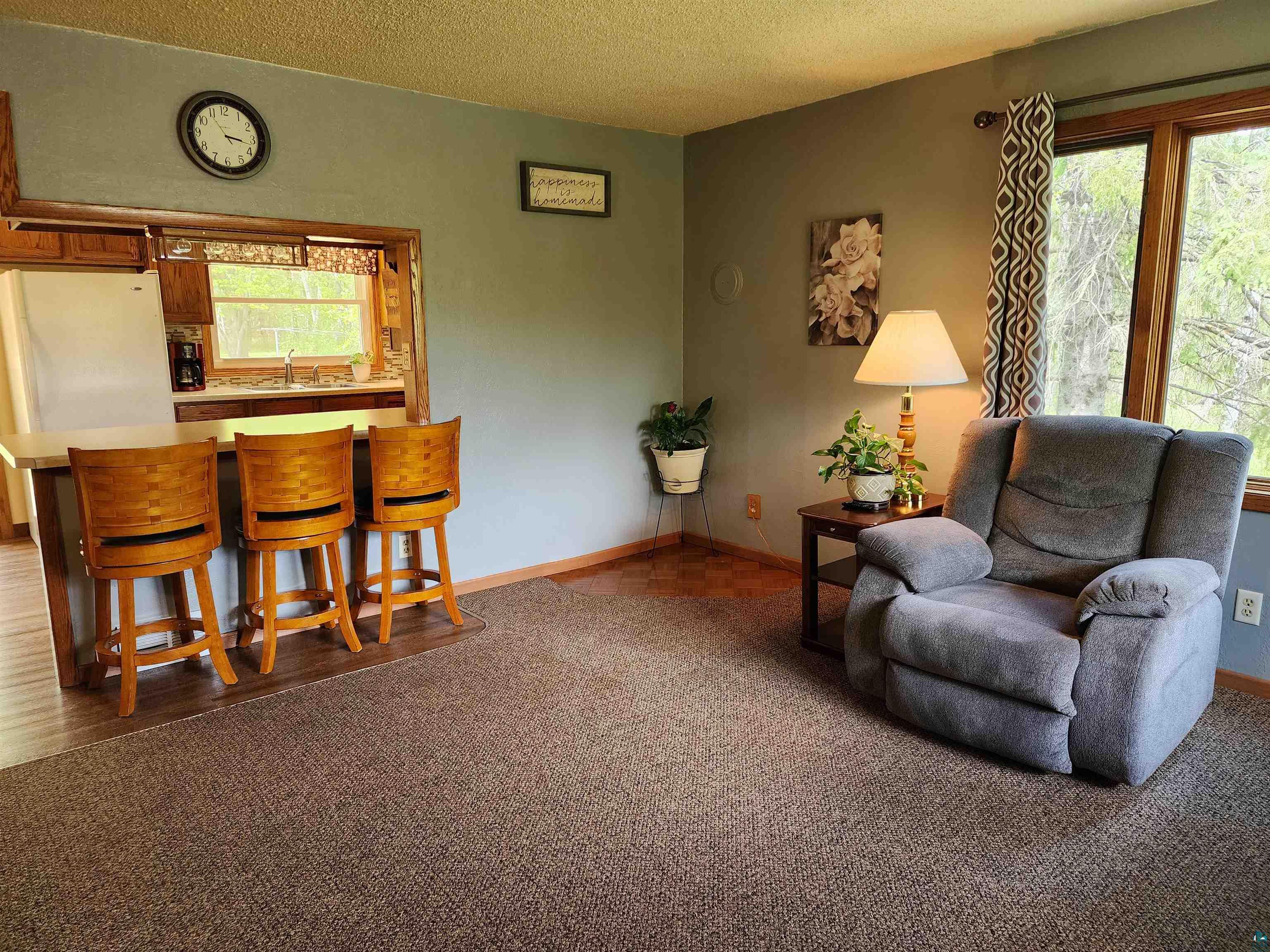 4179 Willard Road Rice Lake, MN 55803 - Photo 9 of 39 Living room featuring plenty of natural light, sink, a textured ceiling, and hardwood / wood-style flooring