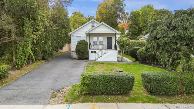 a front view of a house with garden