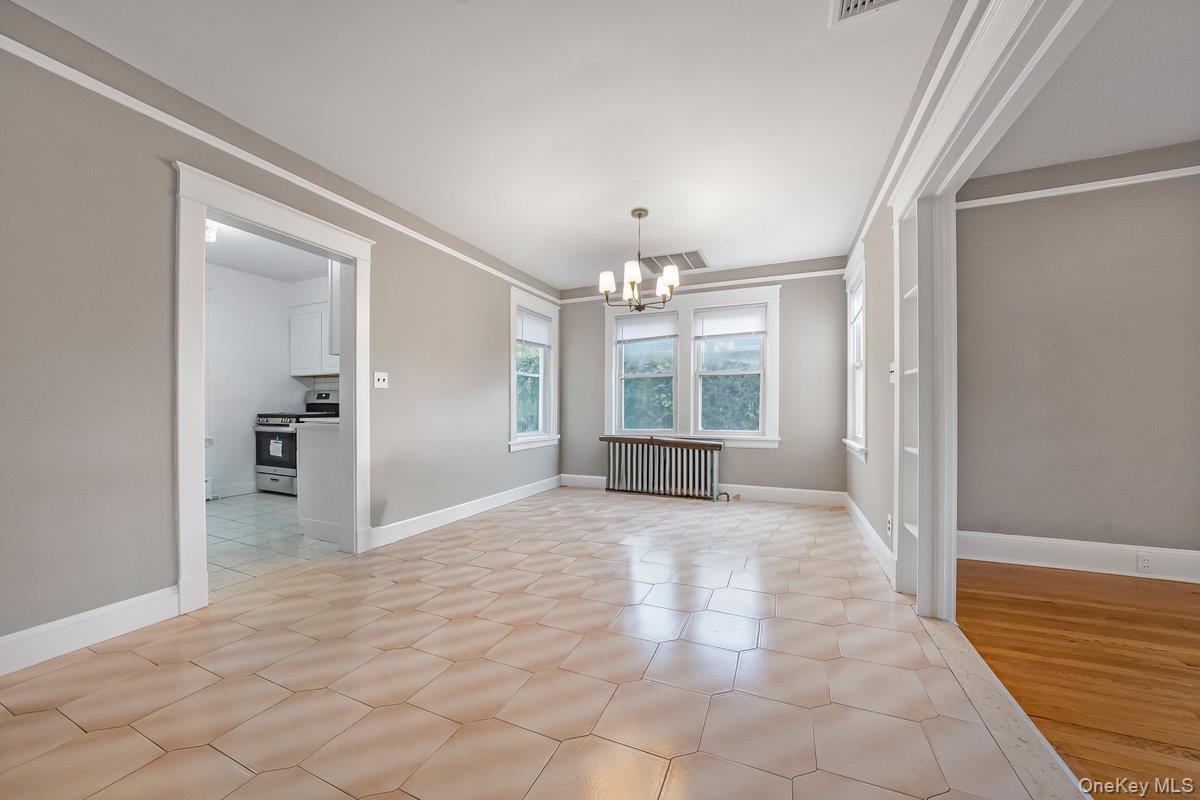 151 Babbitt Road Bedford Hills, NY 10507 - Photo 8 of 23 a view of a hallway with wooden floor and a kitchen