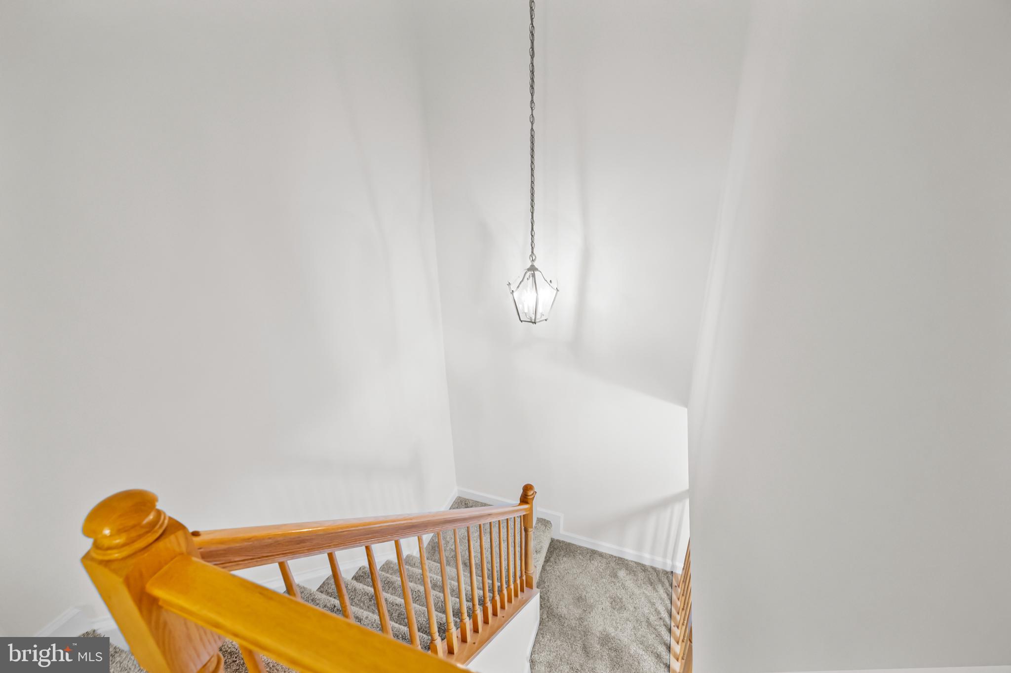 17045 Islip Loop, Unit 303 Dumfries, VA 22026 - Photo 33 of 48 a view of staircase with railing and white walls