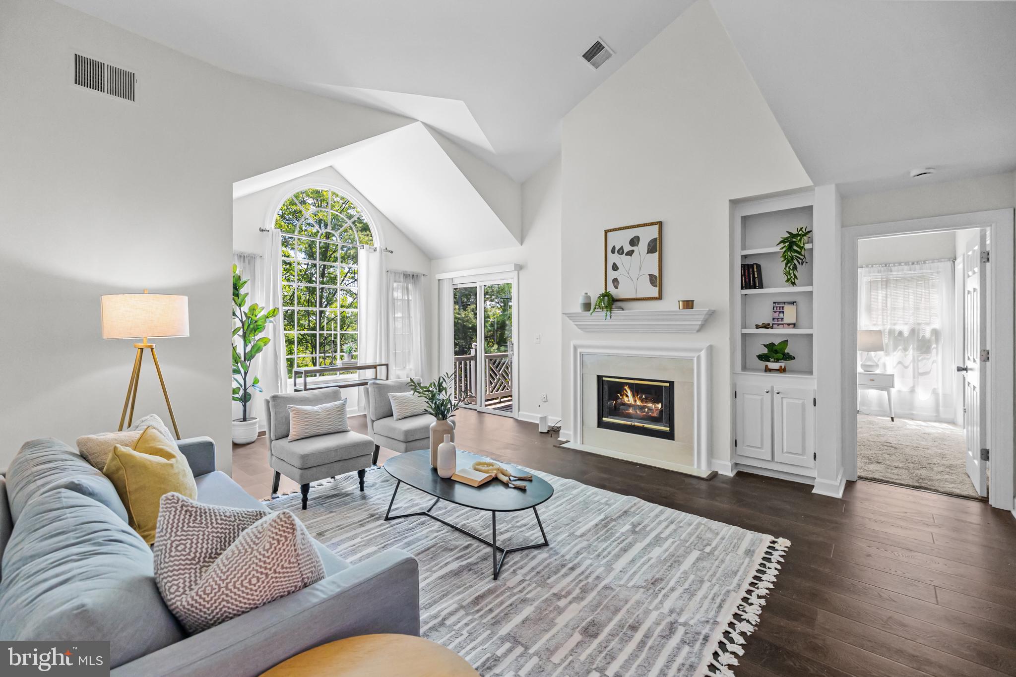 17045 Islip Loop, Unit 303 Dumfries, VA 22026 - Photo 8 of 48 a living room with furniture and a fireplace
