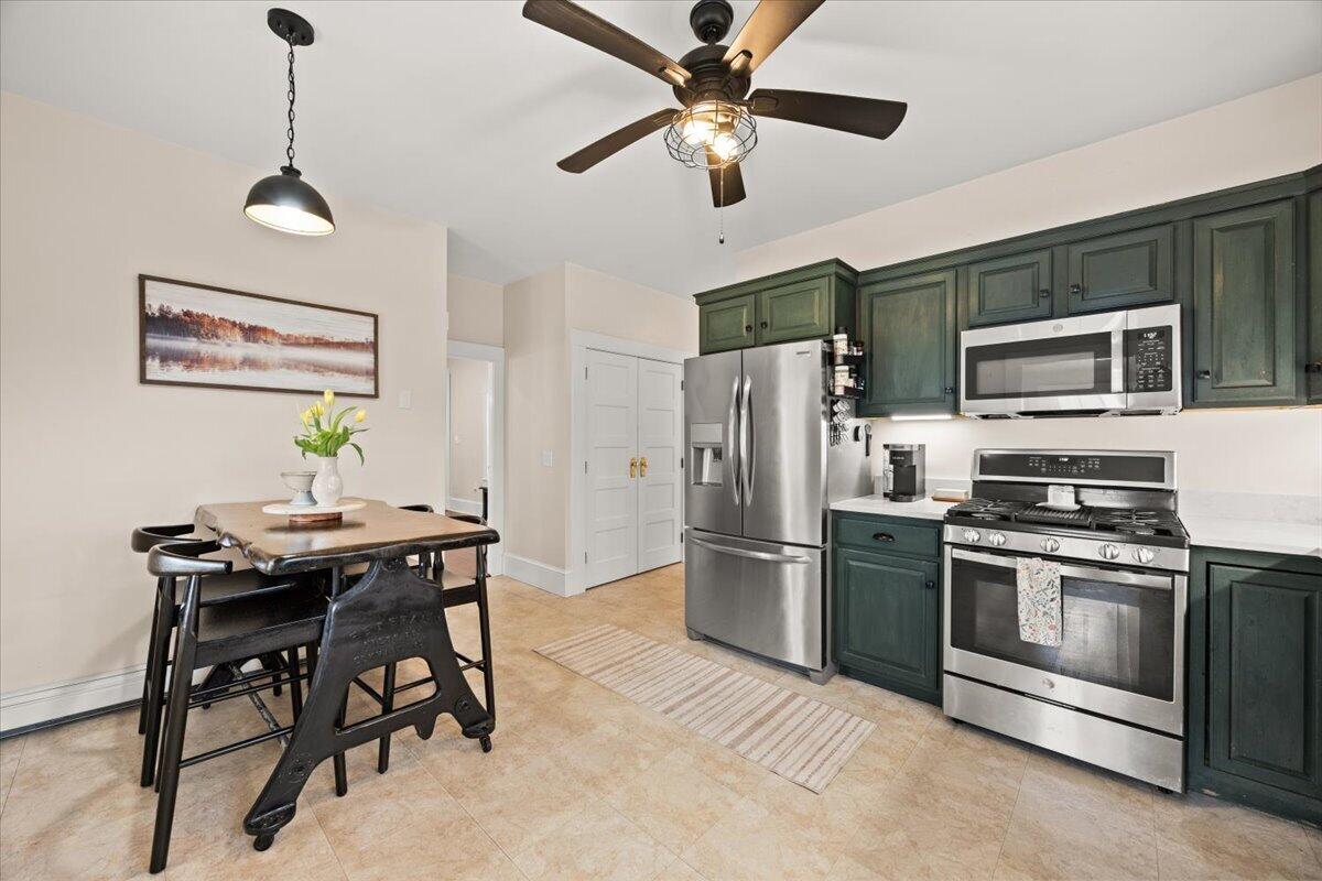 729 Center Street Dighton, MA 02764 - Photo 13 of 62 a living room with stainless steel appliances kitchen island granite countertop furniture and a fireplace