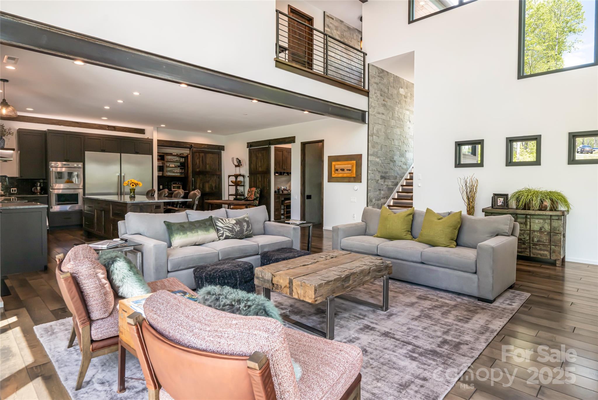 94 Laurel Ledge Way Fletcher, NC 28732 - Photo 12 of 48 a living room with furniture wooden floor and a large window