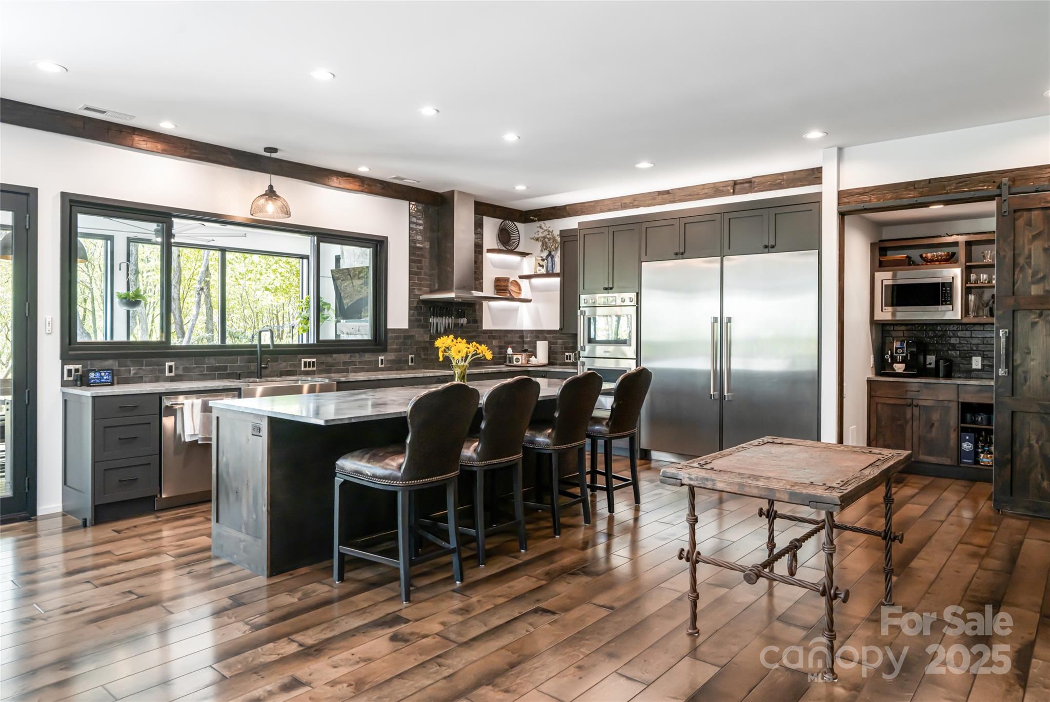 94 Laurel Ledge Way Fletcher, NC 28732 - Photo 15 of 48 a kitchen with a table chairs refrigerator and cabinets