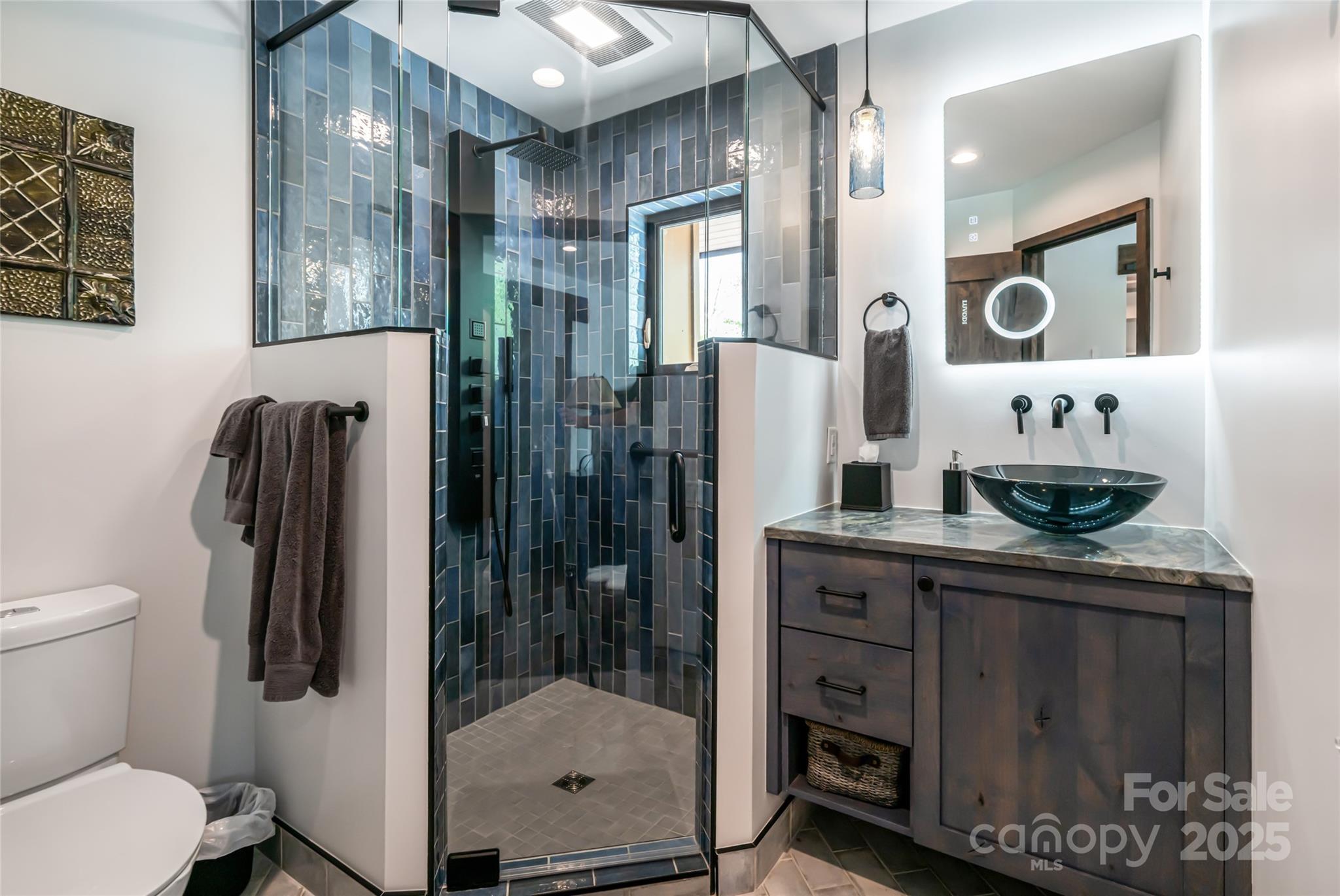 94 Laurel Ledge Way Fletcher, NC 28732 - Photo 37 of 48 a bathroom with a sink a mirror and a shower