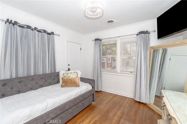 a bedroom with a bed and a chandelier