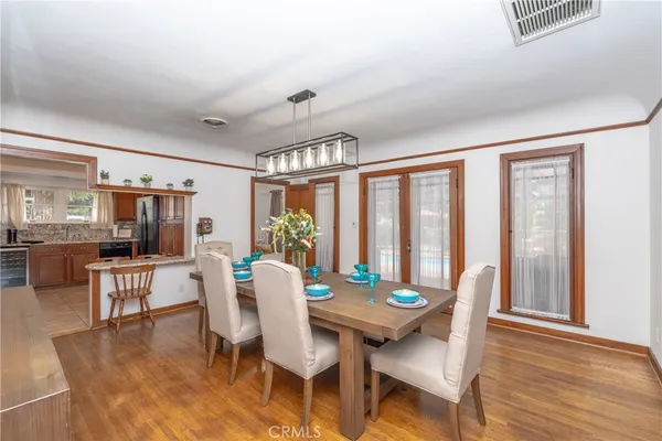 a view of a dining room with furniture wooden floor and chandelier