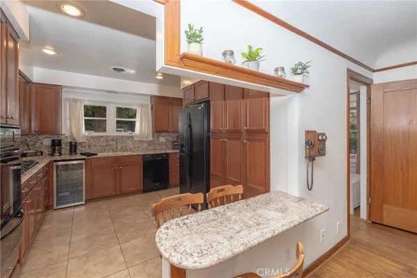 a kitchen with stainless steel appliances granite countertop a stove microwave and sink