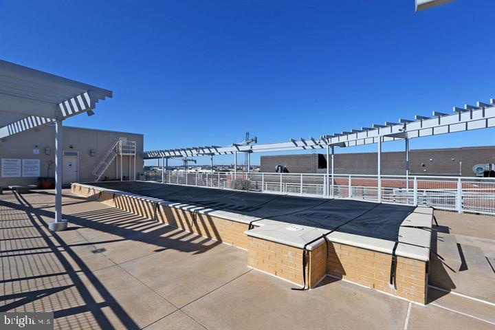 1025 First Street Southeast, Unit 1012 Washington, DC 20003 - Photo 18 of 22 a view of a balcony with two chairs and a potted plant