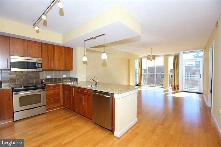 1025 First Street Southeast, Unit 1012 Washington, DC 20003 - Photo 5 of 22 a kitchen with stainless steel appliances granite countertop a stove and a sink
