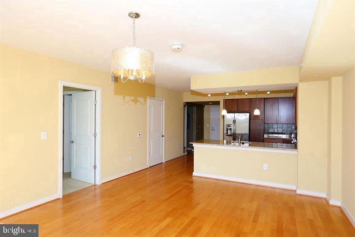 1025 First Street Southeast, Unit 1012 Washington, DC 20003 - Photo 7 of 22 a view of a kitchen with a sink and a refrigerator