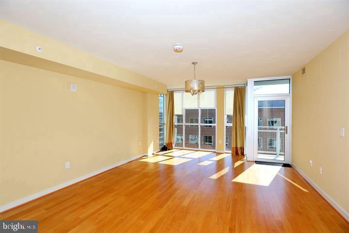 1025 First Street Southeast, Unit 1012 Washington, DC 20003 - Photo 9 of 22 a view of an empty room with wooden floor and a window