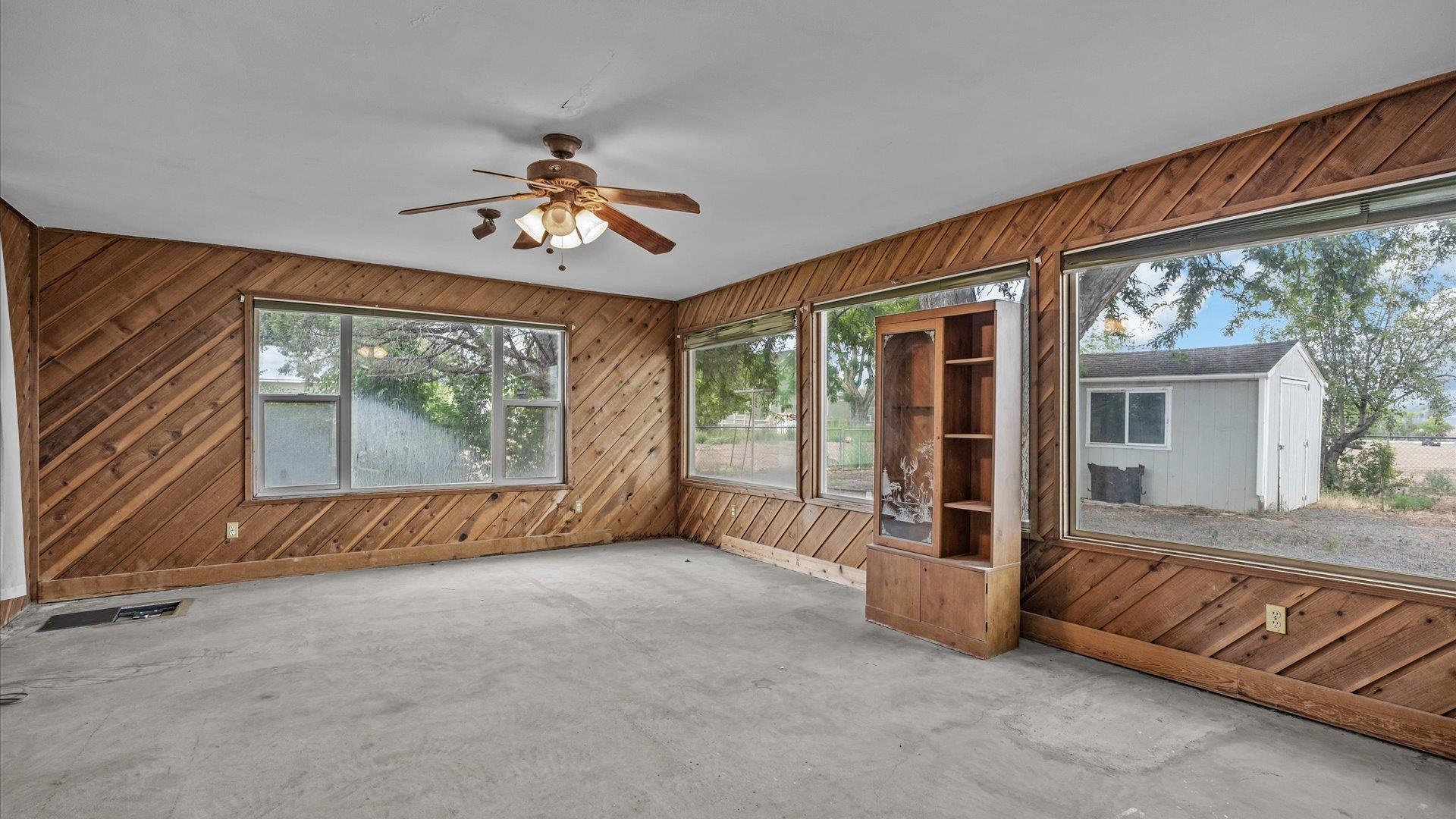 8460 Bobs Road Austin, CO 81410 - Photo 13 of 32 a view of an empty room with a fireplace and a large window