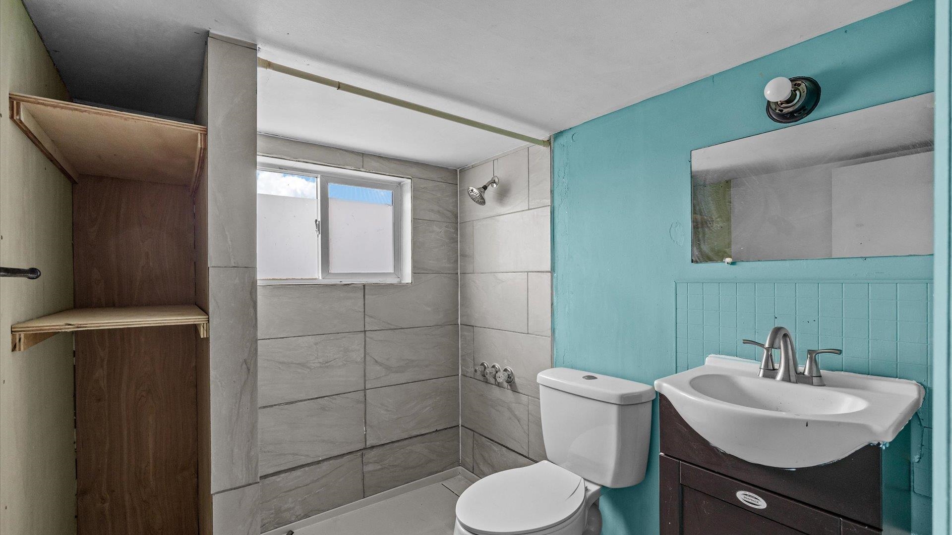 8460 Bobs Road Austin, CO 81410 - Photo 16 of 32 a bathroom with a sink toilet and mirror