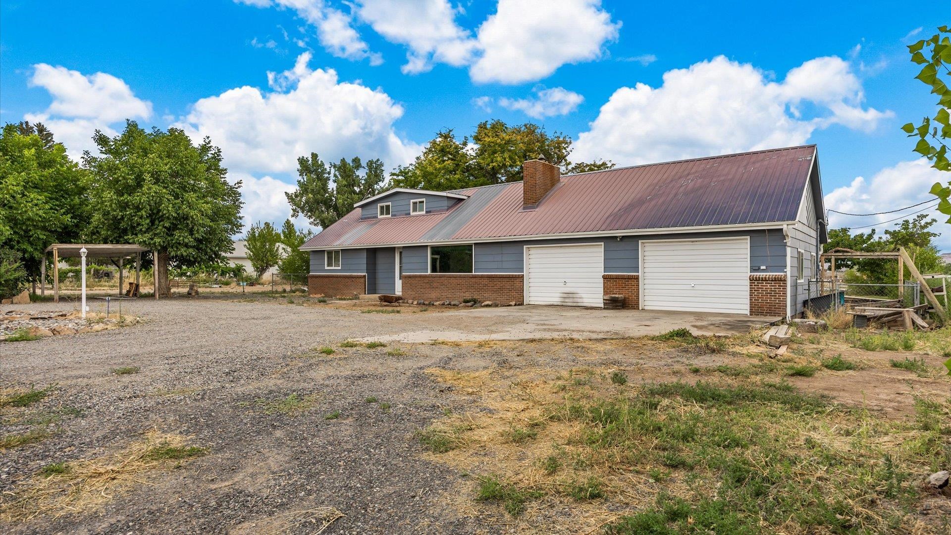 8460 Bobs Road Austin, CO 81410 - Photo 2 of 32 a front view of a house with garden