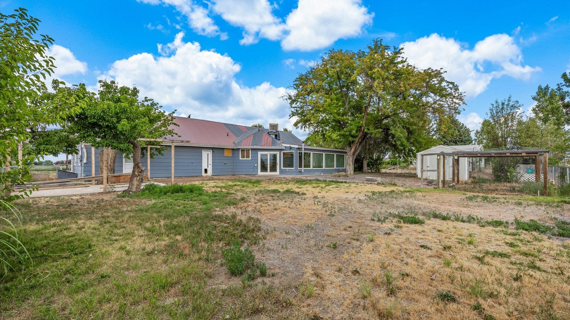8460 Bobs Road Austin, CO 81410 - Photo 24 of 32 a front view of a house with a garden