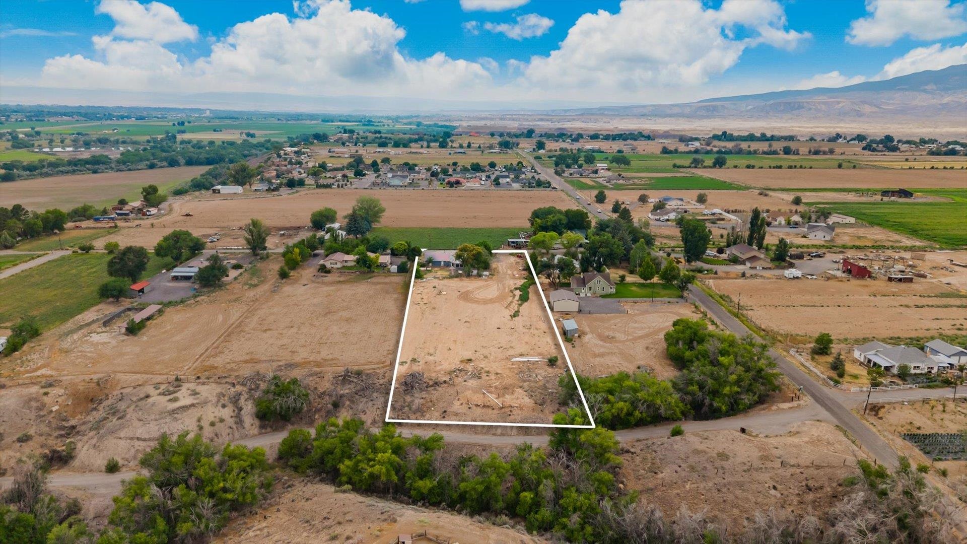 8460 Bobs Road Austin, CO 81410 - Photo 26 of 32 an aerial view of a house with a yard and lake view