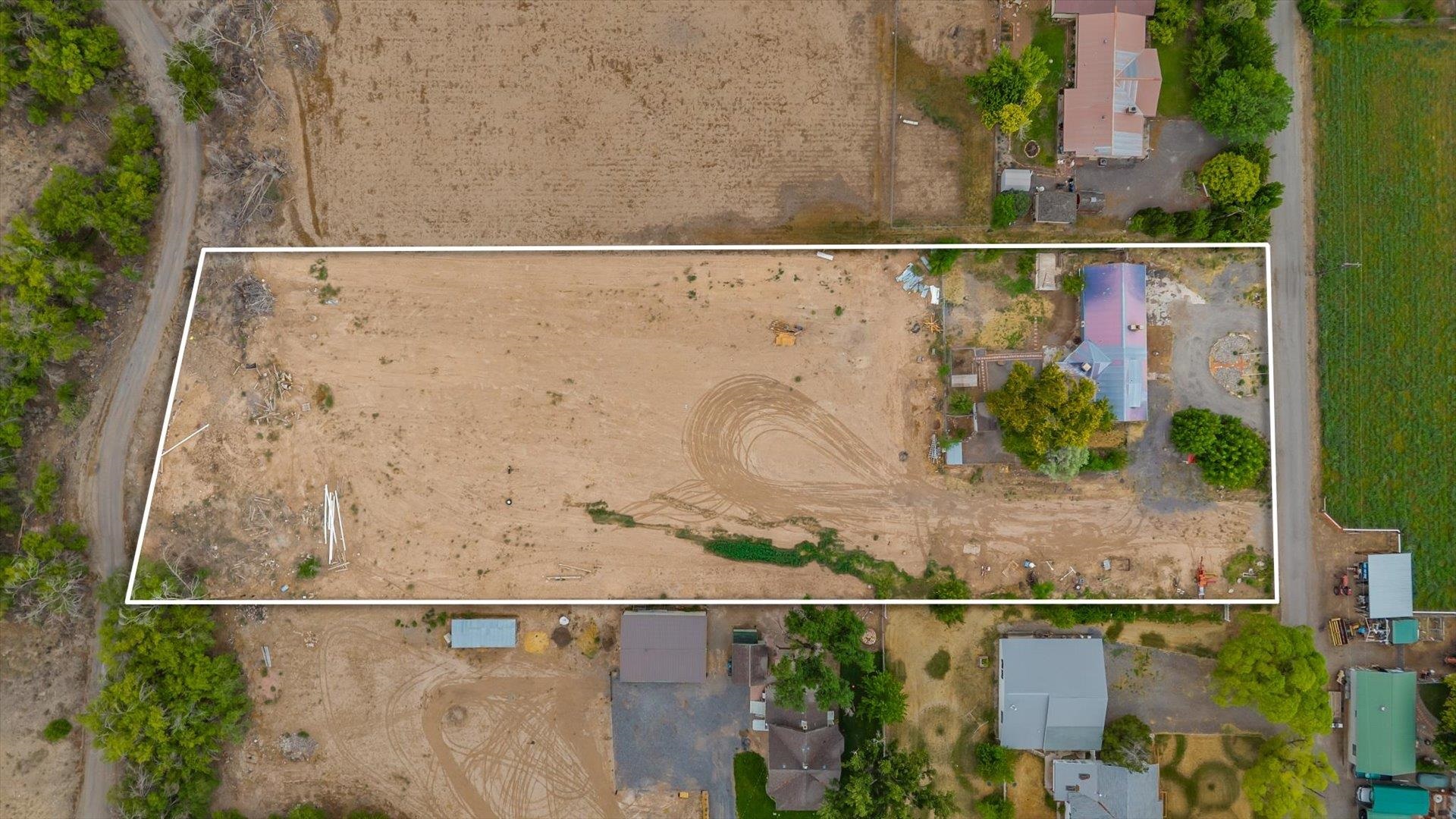 8460 Bobs Road Austin, CO 81410 - Photo 27 of 32 an aerial view of a house with a yard and large trees