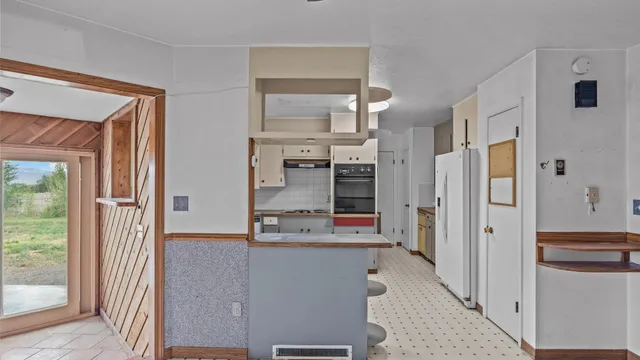 a kitchen with stainless steel appliances a refrigerator and a stove