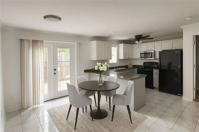 a kitchen with granite countertop a refrigerator and a stove top oven