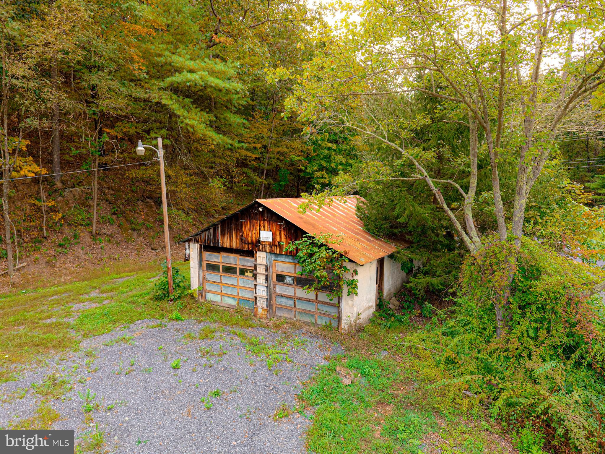 22015 Waterfall Road Three Springs, PA 17264 - Photo 6 of 23 a yellow house with trees in front of it