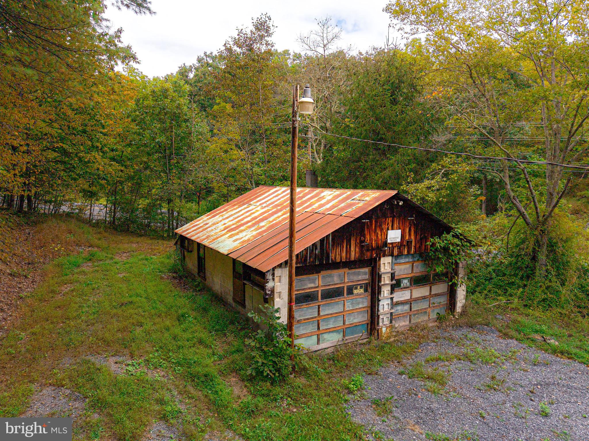 22015 Waterfall Road Three Springs, PA 17264 - Photo 7 of 23 a view of a patio with a table chairs and a yard