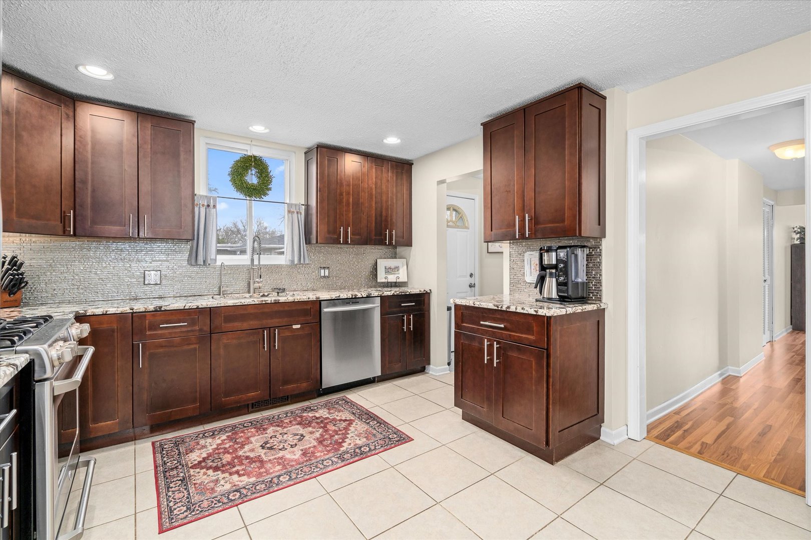 4516 Drendel Road Downers Grove, IL 60515 - Photo 7 of 29 a kitchen with stainless steel appliances granite countertop wooden cabinets a stove top oven and granite counter tops