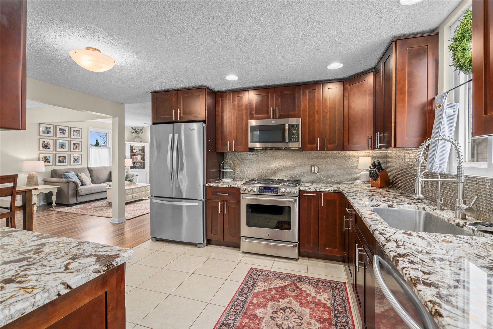 4516 Drendel Road Downers Grove, IL 60515 - Photo 8 of 29 a kitchen with a stove a sink and a refrigerator