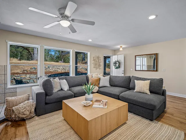 a living room with furniture and a large window