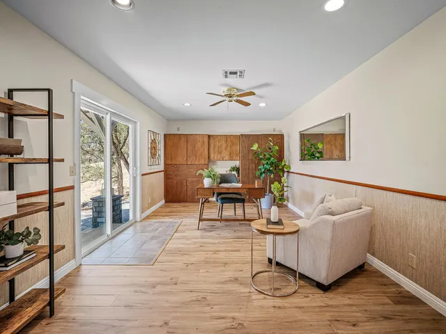 a dining room with furniture a window and wooden floor