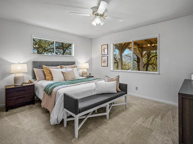 a bathroom with a granite countertop sink a toilet and a mirror