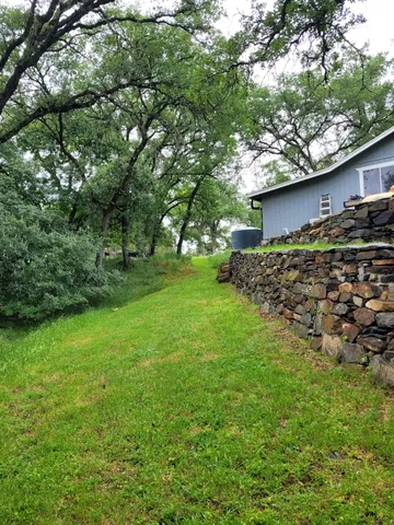 a view of a yard with swimming pool