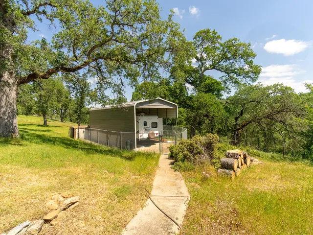 a view of a backyard with swimming pool