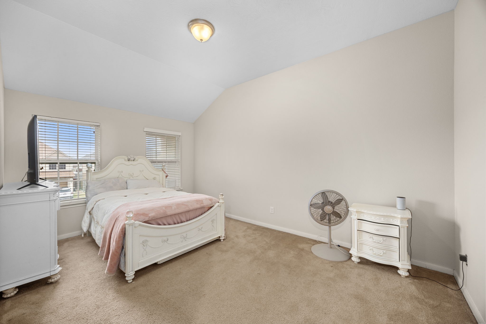 6719 Latchmore Lane Houston, TX 77049 - Photo 36 of 46 a bedroom with a bed and a cabinets