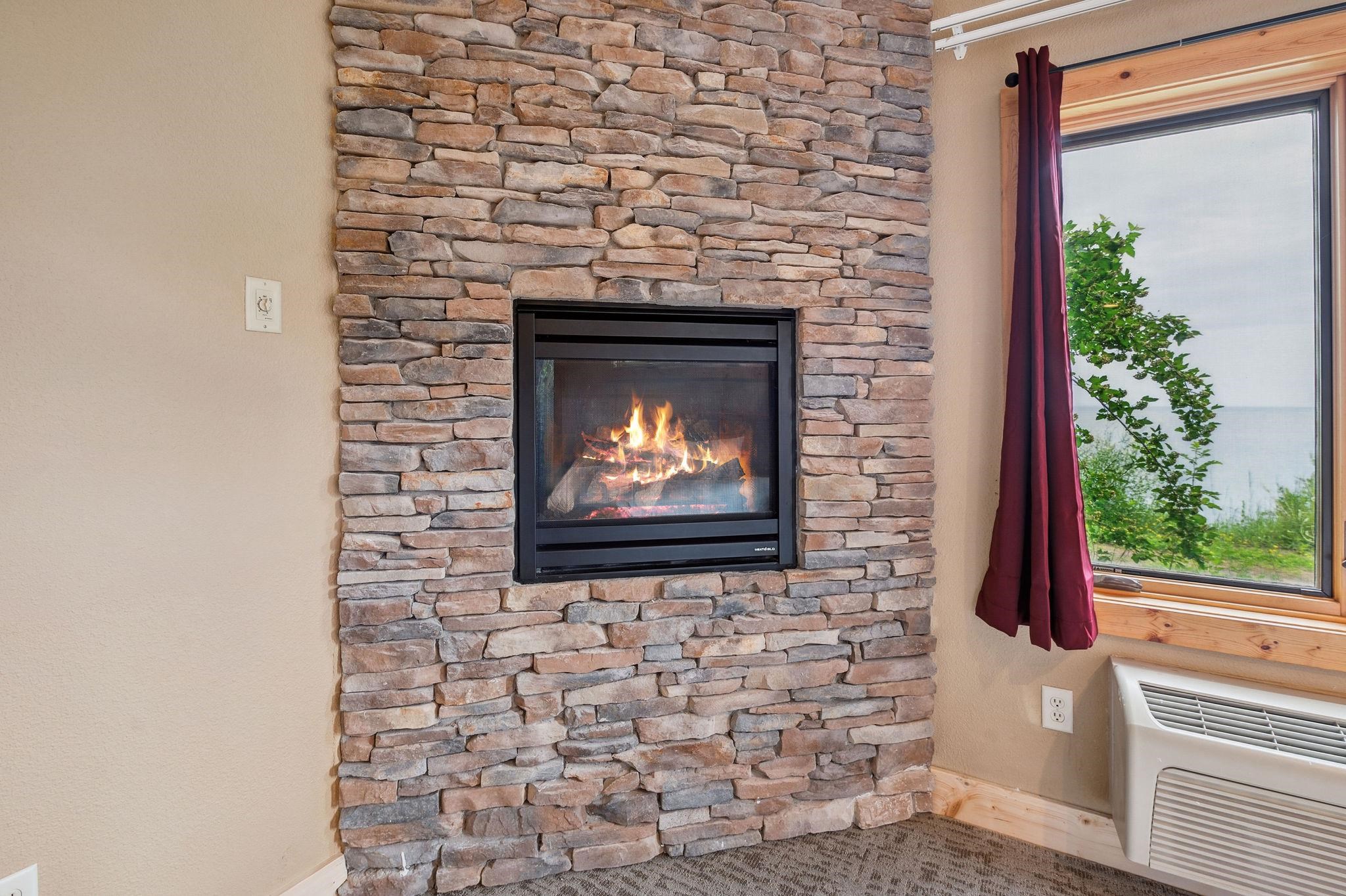 Two Burlington Road, Unit 5102 Two Harbors, MN 55616 - Photo 15 of 30 Detailed view of a wall mounted air conditioner and a fireplace