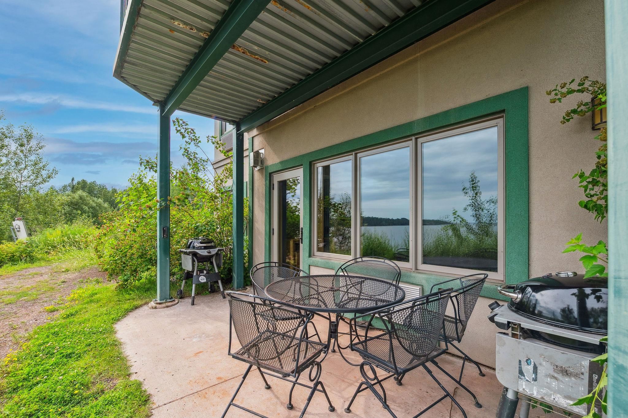 Two Burlington Road, Unit 5102 Two Harbors, MN 55616 - Photo 21 of 30 View of patio / terrace with area for grilling, outdoor dining area, and a water view