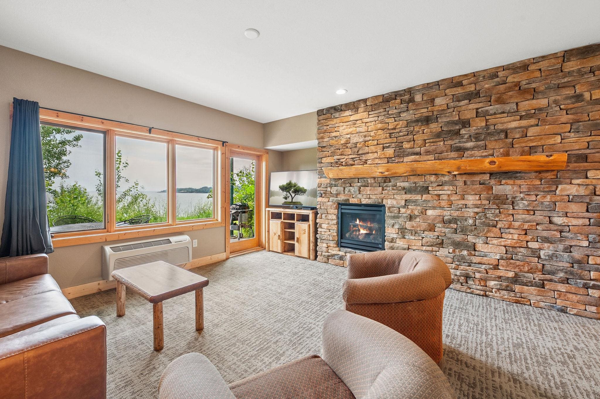 Two Burlington Road, Unit 5102 Two Harbors, MN 55616 - Photo 3 of 30 Carpeted living room with baseboards and a large fireplace