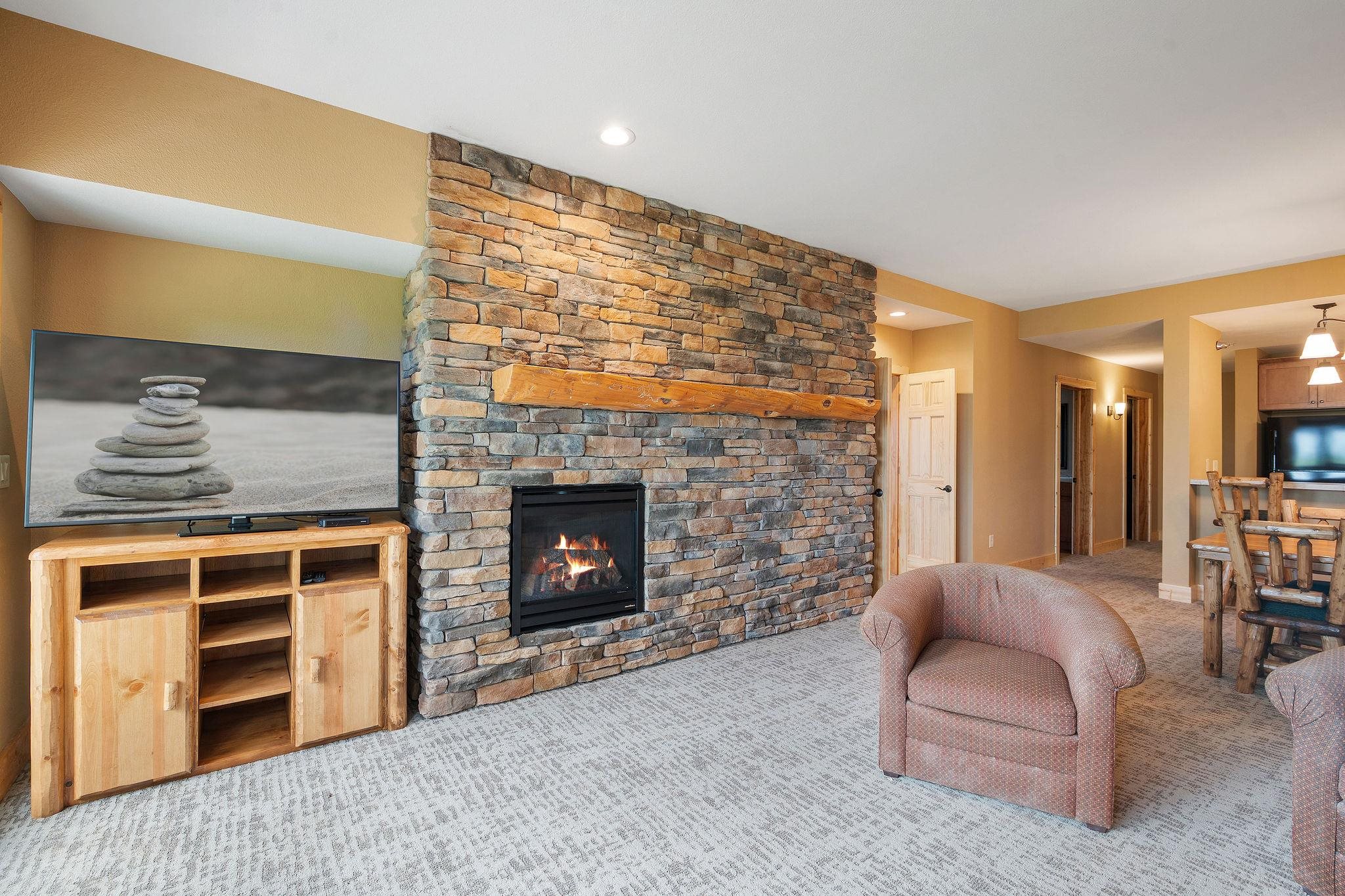 Two Burlington Road, Unit 5102 Two Harbors, MN 55616 - Photo 4 of 30 Carpeted living room with a stone fireplace and recessed lighting