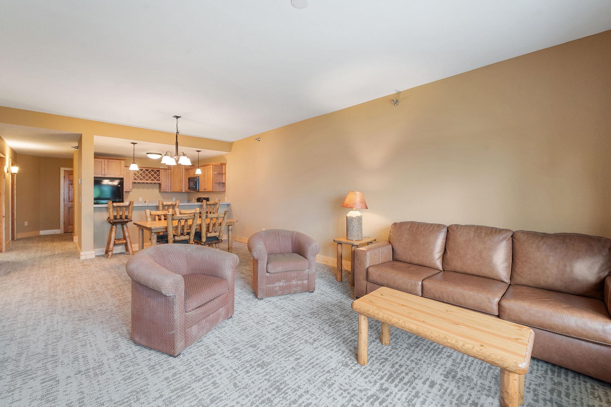 Two Burlington Road, Unit 5102 Two Harbors, MN 55616 - Photo 5 of 30 Living area featuring light colored carpet and a chandelier