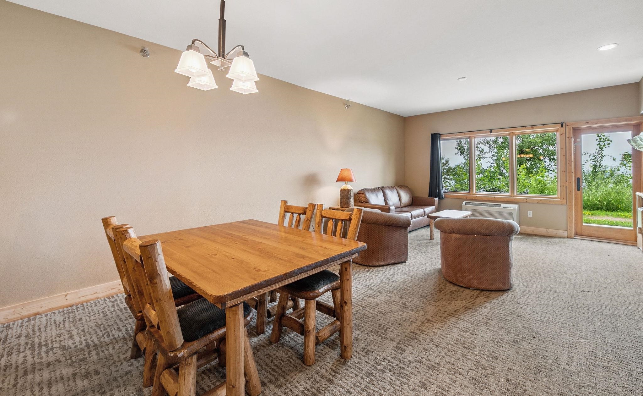 Two Burlington Road, Unit 5102 Two Harbors, MN 55616 - Photo 6 of 30 Carpeted dining space with baseboards and a chandelier