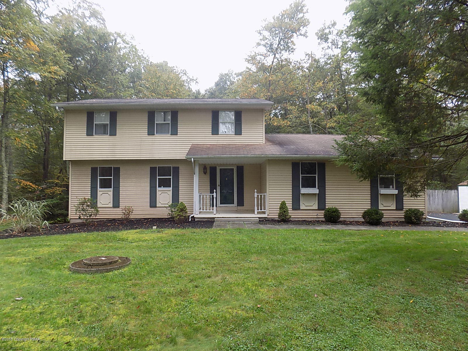 1151 Browning Road East Stroudsburg, PA 18301 - Photo 1 of 19 a front view of a house with a garden and trees