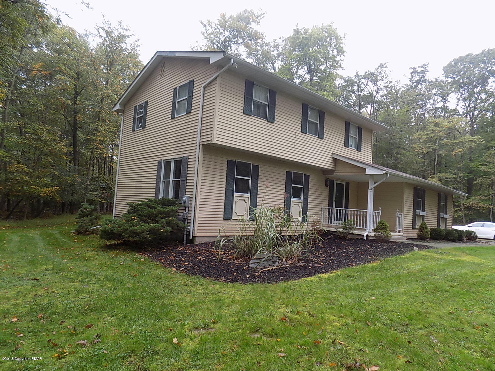 1151 Browning Road East Stroudsburg, PA 18301 - Photo 2 of 19 a front view of a house with a yard and porch
