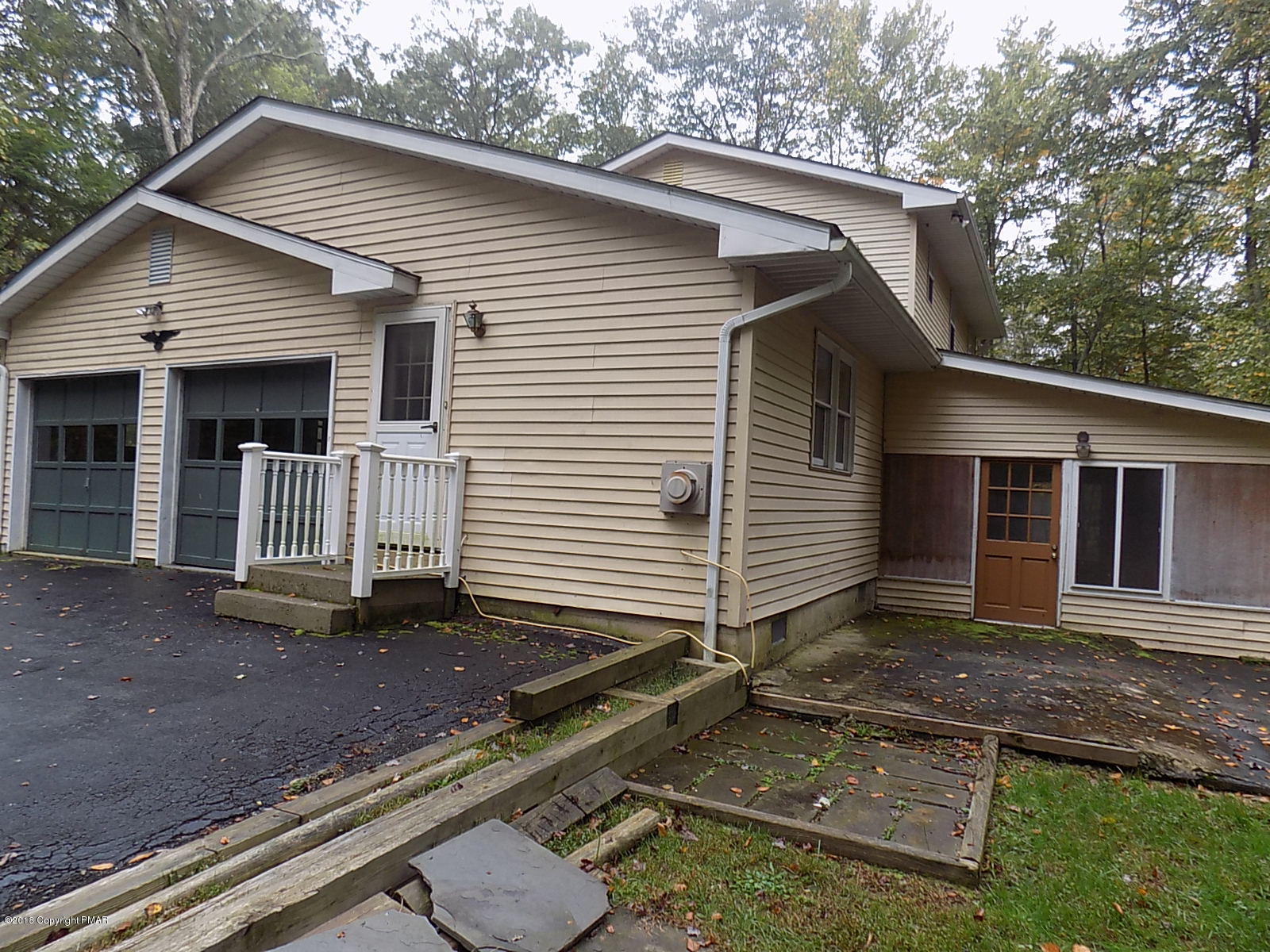1151 Browning Road East Stroudsburg, PA 18301 - Photo 5 of 19 a view of a small house with yard and floor to ceiling window