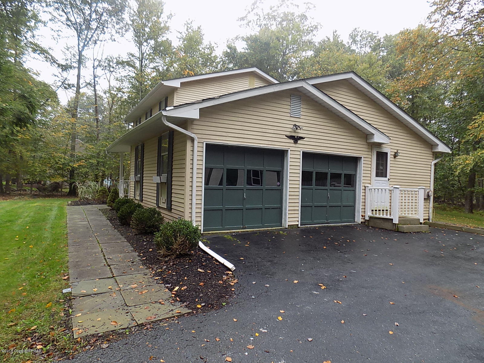 1151 Browning Road East Stroudsburg, PA 18301 - Photo 6 of 19 a front view of a house with a yard and garage