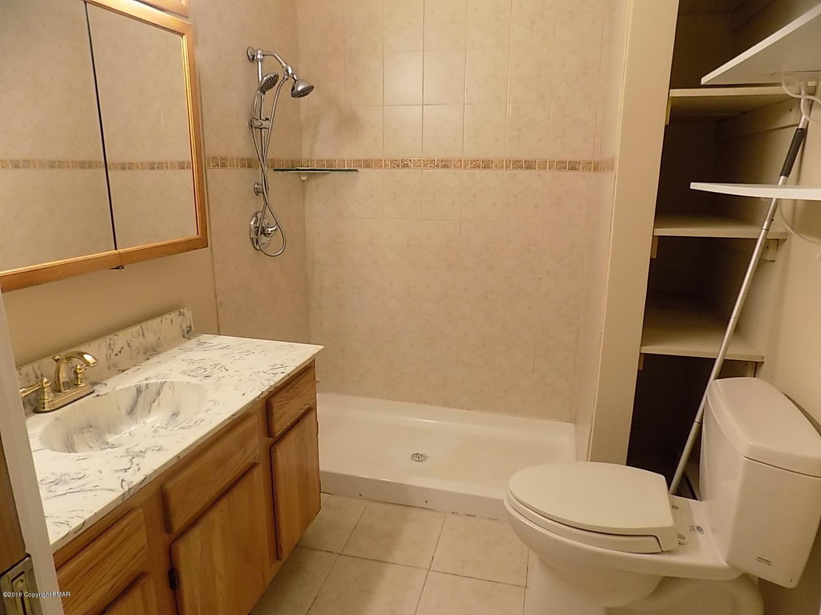 1151 Browning Road East Stroudsburg, PA 18301 - Photo 10 of 19 a bathroom with a granite countertop sink toilet and shower