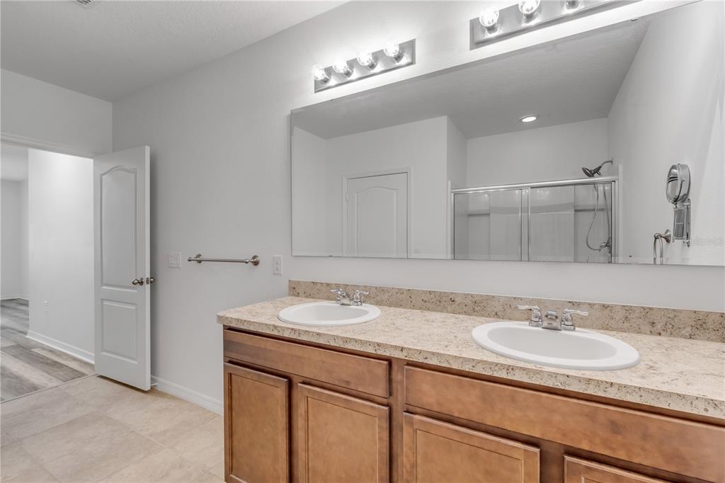 353 Admiralty Court Edgewater, FL 32141 - Photo 23 of 56 a bathroom with a granite countertop sink and a mirror