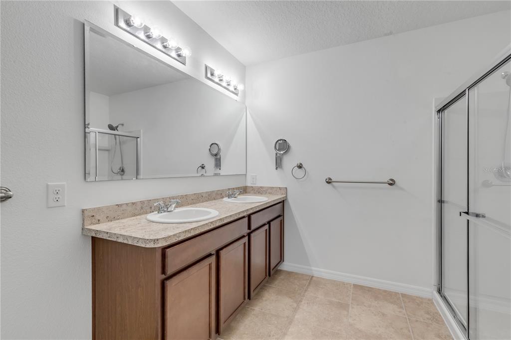 353 Admiralty Court Edgewater, FL 32141 - Photo 24 of 56 a bathroom with a granite countertop sink and a mirror