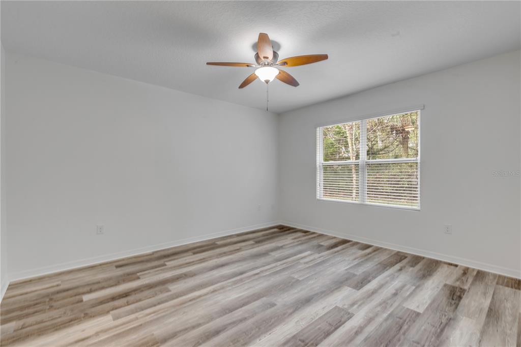 353 Admiralty Court Edgewater, FL 32141 - Photo 31 of 56 wooden floor in an empty room with a window