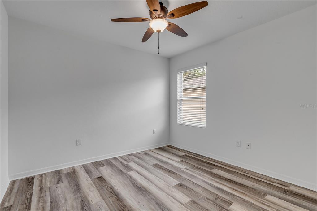 353 Admiralty Court Edgewater, FL 32141 - Photo 33 of 56 wooden floor in an empty room with a window