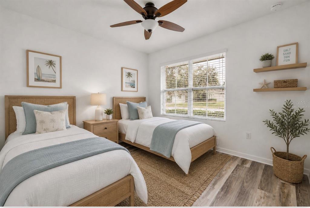 353 Admiralty Court Edgewater, FL 32141 - Photo 35 of 56 a bedroom with two beds and a potted plant